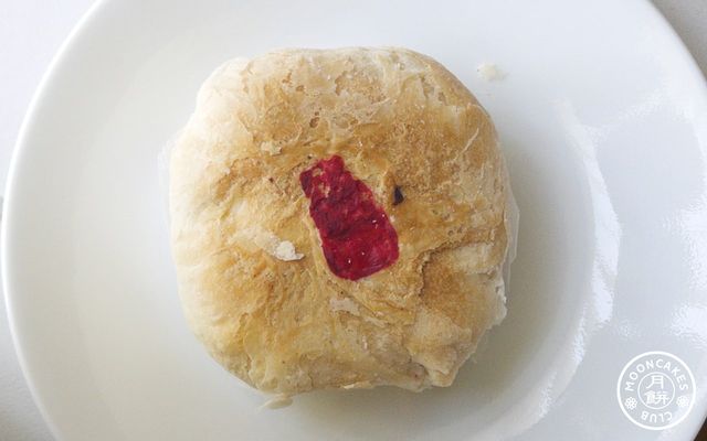 A flaky skin mooncake on a white plate